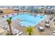 Aerial view of the sparkling community pool with lounge chairs and palm trees at 145 Goldenrod Circle # 7B, Little River, SC 29566