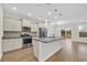 Spacious kitchen featuring stainless steel appliances, a granite island, and modern pendant lighting at 145 Goldenrod Circle # 7B, Little River, SC 29566