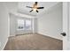 Spacious bedroom with carpet, a ceiling fan, and natural light from large windows at 145 Goldenrod Circle # 7B, Little River, SC 29566