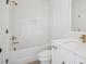 Bright bathroom featuring a shower-tub combo, white tile, and modern fixtures at 1800 Tryon Dr, Myrtle Beach, SC 29588