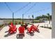 Community fire pit with Adirondack chairs under cafe lighting provides a relaxing outdoor space at 1800 Tryon Dr, Myrtle Beach, SC 29588