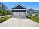 Two car garage with a blue exterior and a concrete driveway at 1800 Tryon Dr, Myrtle Beach, SC 29588