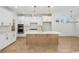 Open kitchen with stainless steel appliances, large center island, and stylish pendant lighting at 1800 Tryon Dr, Myrtle Beach, SC 29588