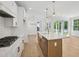 Modern kitchen with white cabinetry, stone countertops, an island and stainless steel appliances at 1800 Tryon Dr, Myrtle Beach, SC 29588