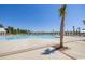 Community swimming pool area featuring palm trees, white pergolas, and ample lounge seating at 1800 Tryon Dr, Myrtle Beach, SC 29588