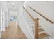 Bright, modern staircase featuring wood treads, white risers and walls, and minimalist design at 1800 Tryon Dr, Myrtle Beach, SC 29588