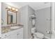 Well-lit bathroom featuring a vanity with granite countertop, toilet, and fresh towels at 1819 Ocean Blvd. N # 1403, North Myrtle Beach, SC 29582