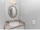 Bathroom with a stylish vanity and a modern round mirror at 1819 Ocean Blvd. N # 1403, North Myrtle Beach, SC 29582