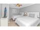 Comfortable bedroom featuring two twin beds, a ceiling fan, and neutral decor at 1819 Ocean Blvd. N # 1403, North Myrtle Beach, SC 29582