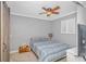 Cozy bedroom with a queen bed, stylish decor, and a ceiling fan at 1819 Ocean Blvd. N # 1403, North Myrtle Beach, SC 29582