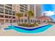 Resort-style pool area with palm trees and plenty of lounge chairs at 1819 Ocean Blvd. N # 1403, North Myrtle Beach, SC 29582