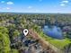 Picturesque aerial view of a residential area featuring a tranquil lake surrounded by lush greenery at 1822 Topsail Ln., North Myrtle Beach, SC 29582