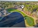 Scenic aerial view of a golf course community with a lake and lush greenery at 1822 Topsail Ln., North Myrtle Beach, SC 29582