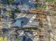 Overhead view of a property with a long driveway, manicured landscaping, and mature trees at 1822 Topsail Ln., North Myrtle Beach, SC 29582