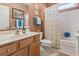 Warm-toned bathroom featuring a single vanity, framed artwork, and a shower-tub combination with a patterned curtain at 1822 Topsail Ln., North Myrtle Beach, SC 29582