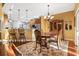 Elegant dining room featuring a wooden table and chairs under a chandelier, flowing into the kitchen at 1822 Topsail Ln., North Myrtle Beach, SC 29582