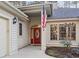 Inviting front entry featuring a bright red door with oval glass inset and a decorative transom window at 1822 Topsail Ln., North Myrtle Beach, SC 29582