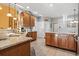 Bright kitchen with granite countertops, wooden cabinets, and tiled floor at 1822 Topsail Ln., North Myrtle Beach, SC 29582