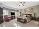 Spacious main bedroom featuring large windows, comfortable seating, and a ceiling fan at 1822 Topsail Ln., North Myrtle Beach, SC 29582