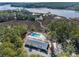 Aerial view of a community pool, clubhouse, dock, tennis court, and waterfront at 2120 Adams Way, Little River, SC 29566