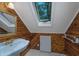 Bathroom features wood paneling, a sink with gold fixtures, and a skylight above at 2120 Adams Way, Little River, SC 29566