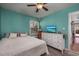 Cozy bedroom features teal walls, ceiling fan, dresser with TV, and a comfortable queen-sized bed at 2120 Adams Way, Little River, SC 29566