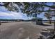 View of parking area and water with distant pier, trees and USA flag at 2120 Adams Way, Little River, SC 29566