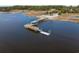 Aerial view of a pier featuring covered seating and a boat launch in a scenic waterfront setting at 2120 Adams Way, Little River, SC 29566