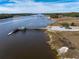 Scenic aerial shot of a long wooden pier with a covered gazebo extending into the water at 2120 Adams Way, Little River, SC 29566