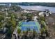 Aerial view of blue and green tennis courts surrounded by lush greenery, near the water at 2120 Adams Way, Little River, SC 29566