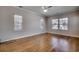 Large bedroom with hardwood floors, white trim, neutral walls, and bright, natural light at 223 Gloucester Way, Little River, SC 29566