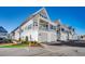 Beautiful exterior of townhomes with private garages, balconies, and manicured landscaping at 223 Gloucester Way, Little River, SC 29566