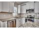 Well-equipped kitchen with stainless steel appliances, granite countertops, and a stylish backsplash at 223 Gloucester Way, Little River, SC 29566