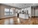 Kitchen and Dining Area: Modern kitchen with stainless steel appliances, granite counters, and bright lighting at 223 Gloucester Way, Little River, SC 29566