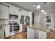 Bright kitchen with white cabinets, stainless steel appliances, and granite countertops at 223 Gloucester Way, Little River, SC 29566