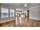 Open-concept living space featuring hardwood floors, kitchen with granite countertops and white cabinets at 223 Gloucester Way, Little River, SC 29566