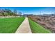 Concrete walkway through a beautifully landscaped park with grass and river views at 223 Gloucester Way, Little River, SC 29566