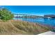 Scenic view of the waterway with a bridge, lush greenery, and clear blue skies at 223 Gloucester Way, Little River, SC 29566