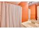 Cozy bathroom with shower, vanity, and vertically striped shower curtain at 2402 N Ocean Blvd., North Myrtle Beach, SC 29582