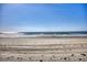 Sandy beach with gentle waves and clear blue sky at 2402 N Ocean Blvd., North Myrtle Beach, SC 29582