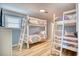 Bedroom featuring two sets of bunk beds with colorful mandala patterned comforters and blue walls at 2402 N Ocean Blvd., North Myrtle Beach, SC 29582