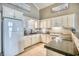 Bright kitchen featuring white cabinets, modern appliances, and a breakfast bar for seating at 2402 N Ocean Blvd., North Myrtle Beach, SC 29582