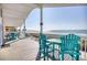 Charming ocean view porch features a bright blue seating area for enjoying the outdoors at 2402 N Ocean Blvd., North Myrtle Beach, SC 29582