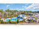 Aerial shot showcasing the community pool with a cabana, playground and lounge area at 2475 Blue Crane Circle # 103, Myrtle Beach, SC 29577