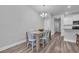 Bright dining area features a wooden table, white chairs, and a modern chandelier for a cozy eating space at 2475 Blue Crane Circle # 103, Myrtle Beach, SC 29577