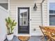 A front door leads to outdoor seating, complemented by a potted plant at 2475 Blue Crane Circle # 103, Myrtle Beach, SC 29577