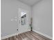 Minimalist hallway features a door with glass panel and vase with decorative sticks at 2475 Blue Crane Circle # 103, Myrtle Beach, SC 29577