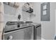 Laundry room features modern gray appliances and shelving for organized and convenient laundry tasks at 2475 Blue Crane Circle # 103, Myrtle Beach, SC 29577