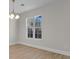 Bright living room with wood floors and a window offering natural light and a modern chandelier at 2483 Morlynn Dr., Myrtle Beach, SC 29577