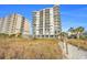 A view of the condo building near dunes, with a pathway to the beach at 2501 S Ocean Blvd. # 206, North Myrtle Beach, SC 29582